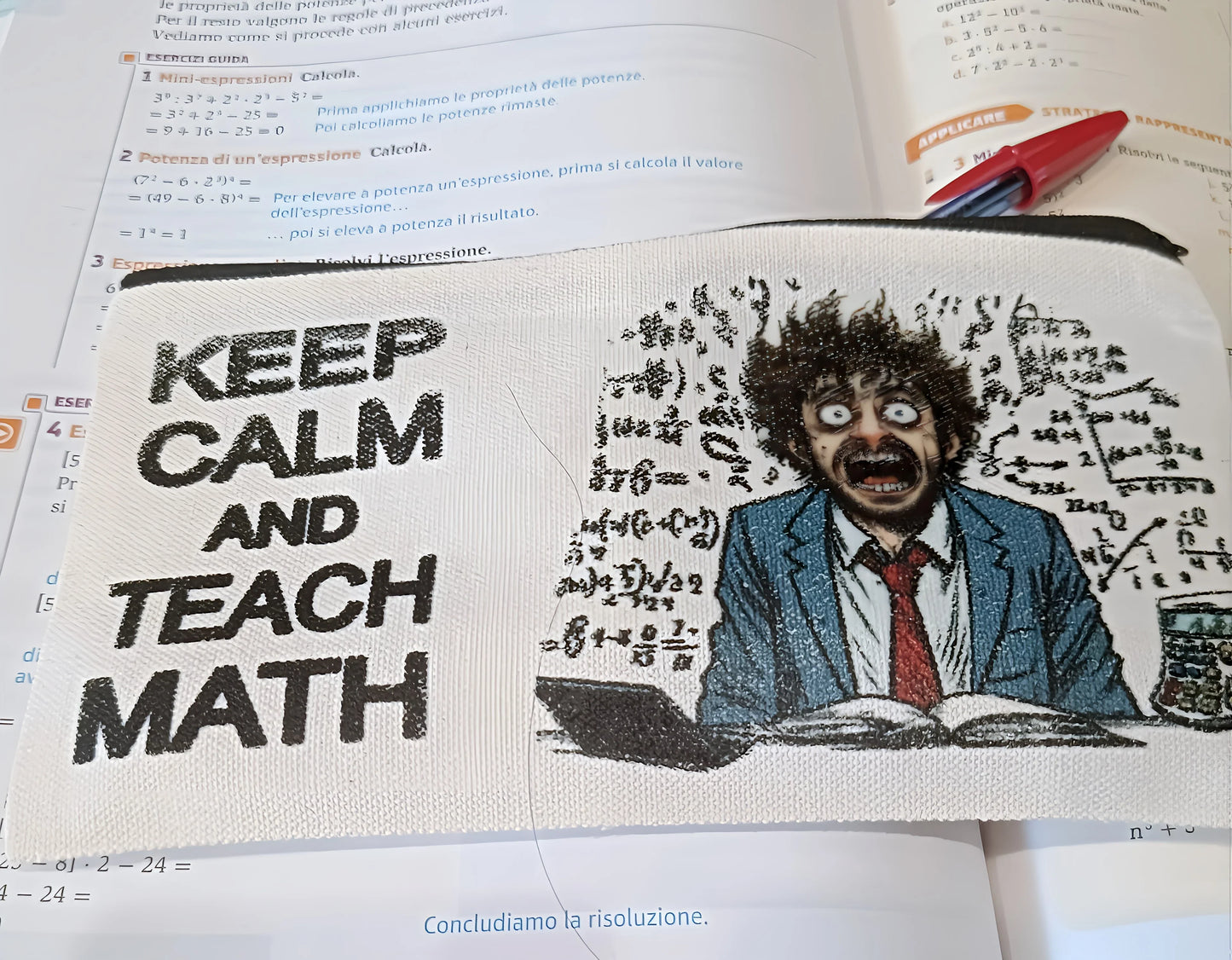 Math pencil case with 'Keep Calm and Teach Math' and a stressed teacher cartoon, on textbook