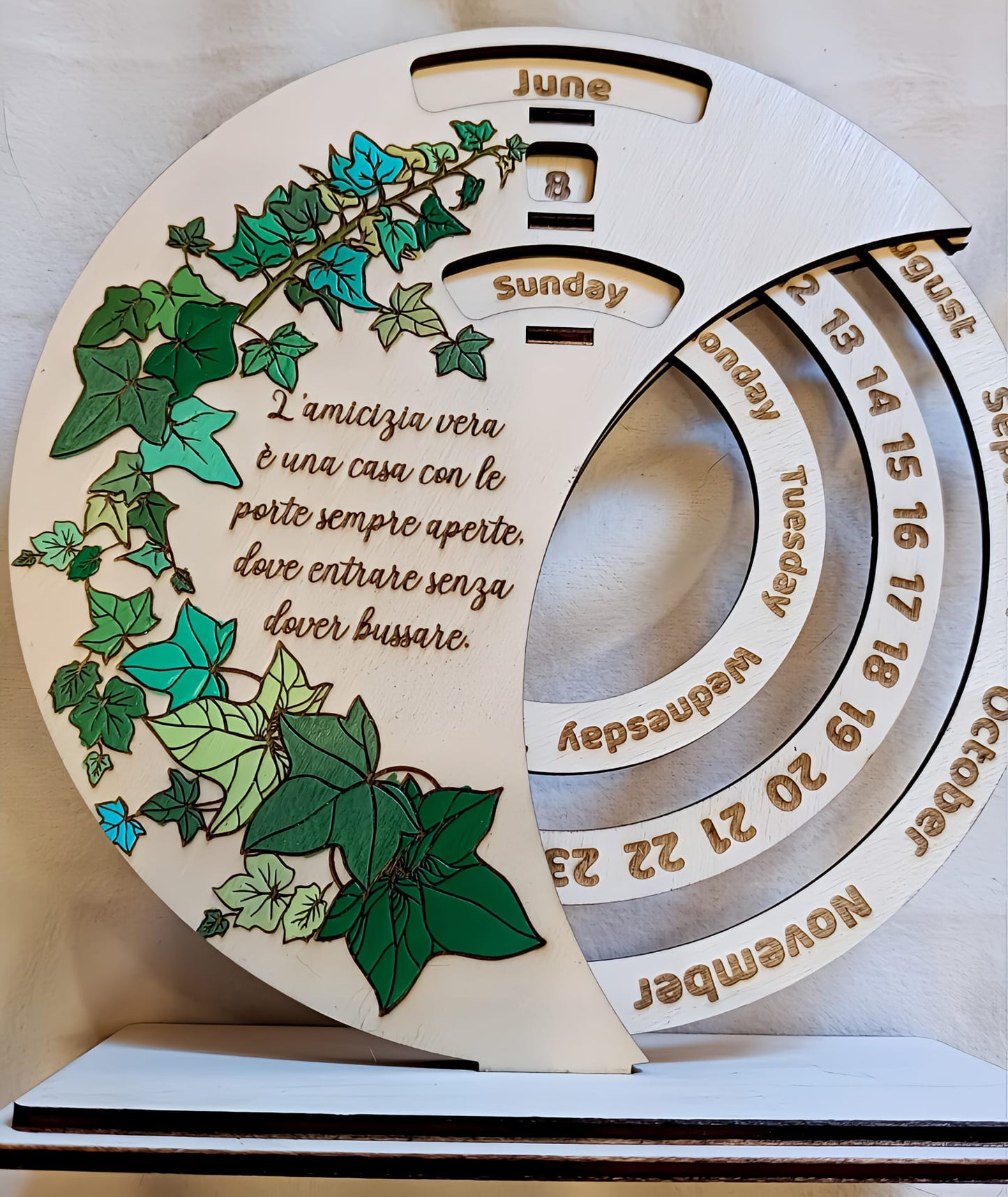 Wooden perpetual calendar with colorful ivy leaves, Italian friendship quote, and rotating date rings.