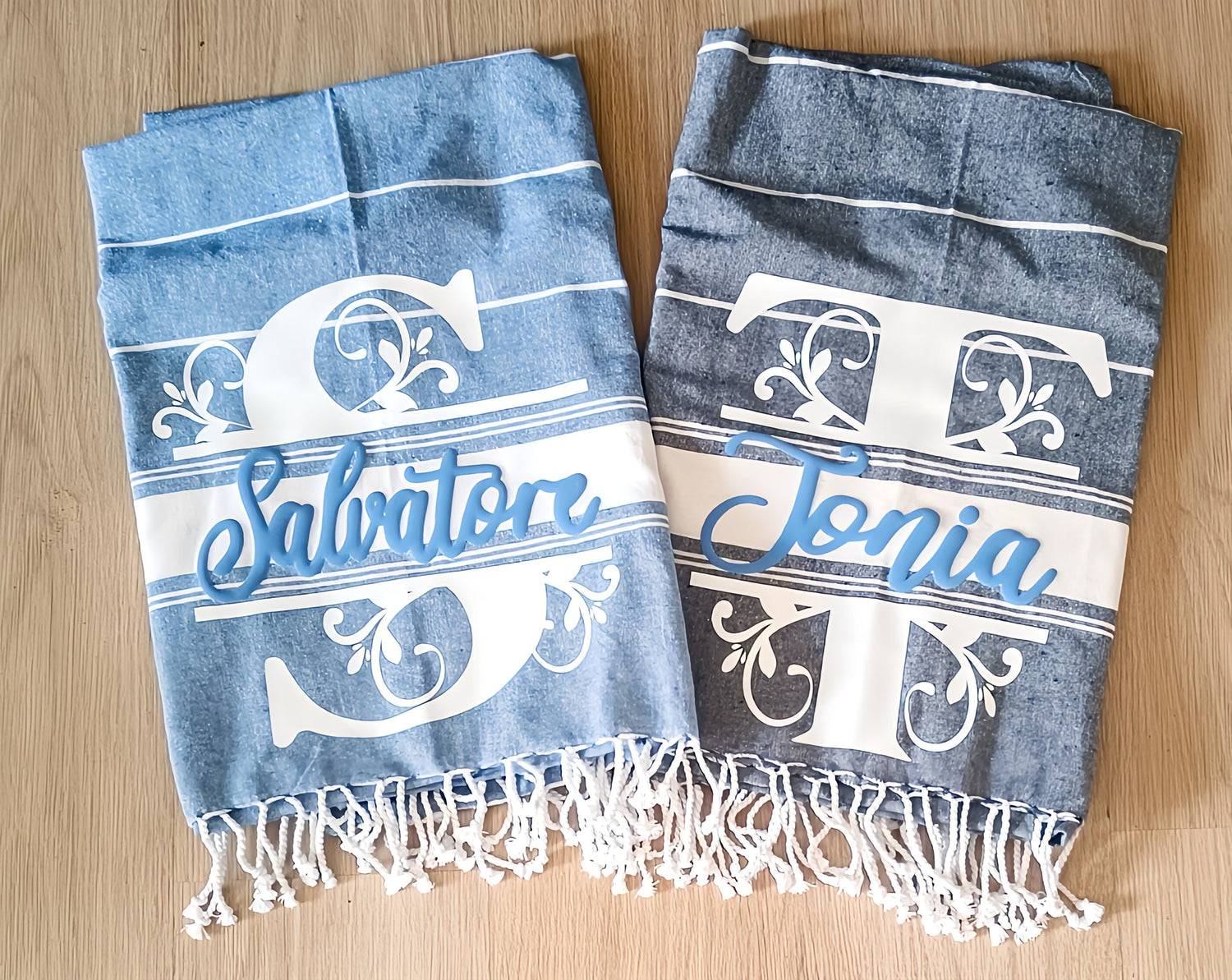Personalized blue Turkish towels with names Salvatore and Tonia on wooden floor