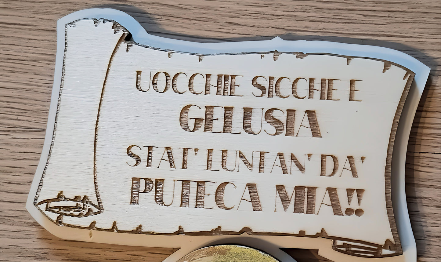Wooden plaque with Italian engraved text on a rustic wood surface