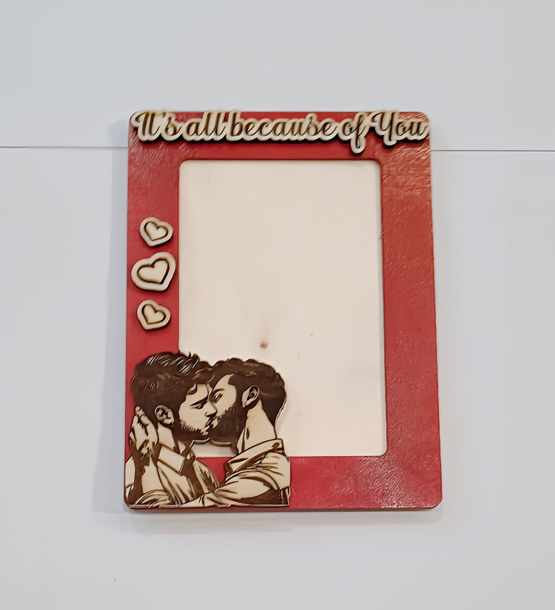 Red photo frame with kissing couple, heart icons, and 'It's all because of you' text