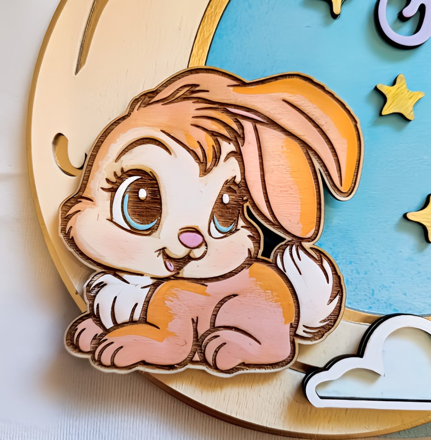 Cute cartoon bunny illustration on wooden moon and stars wall decor