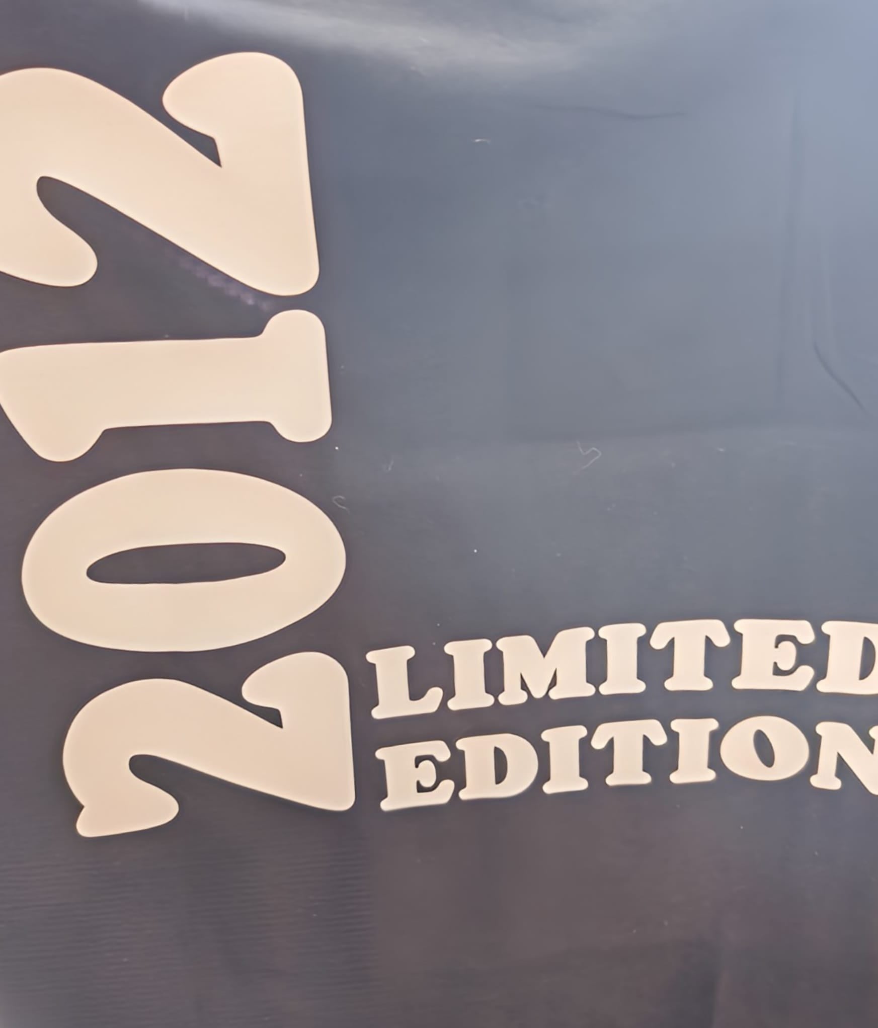 2012 limited edition text on dark background, bold cream letters