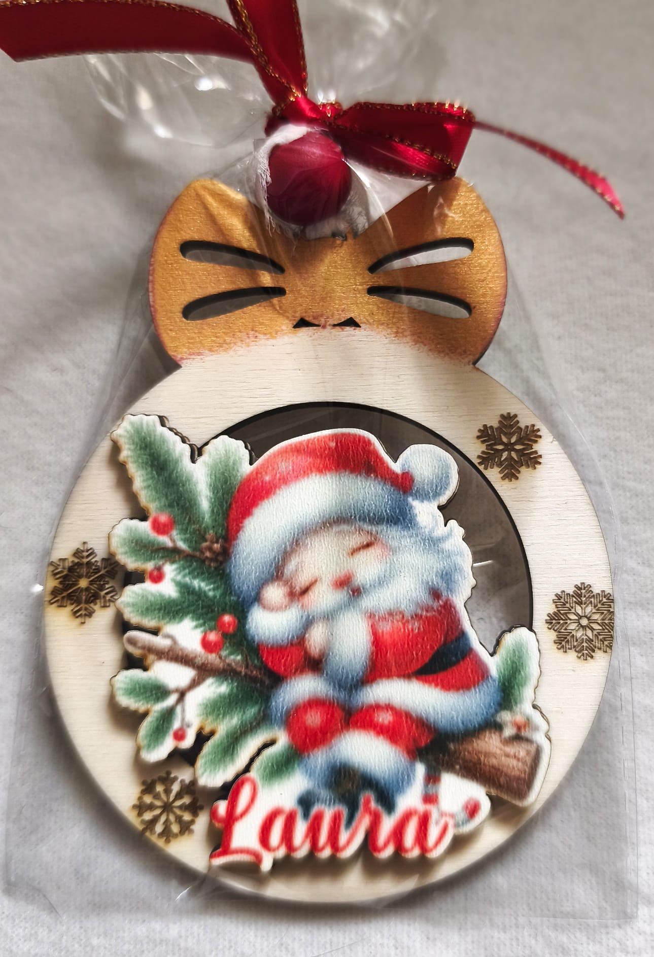 Personalized wooden cat Christmas ornament with Santa, snowflakes, and the name Laura