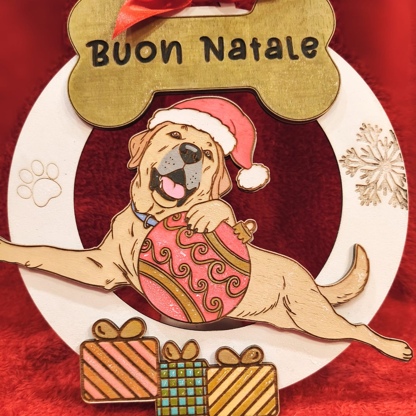Christmas dog ornament with Santa hat, gifts, Buon Natale sign, red background