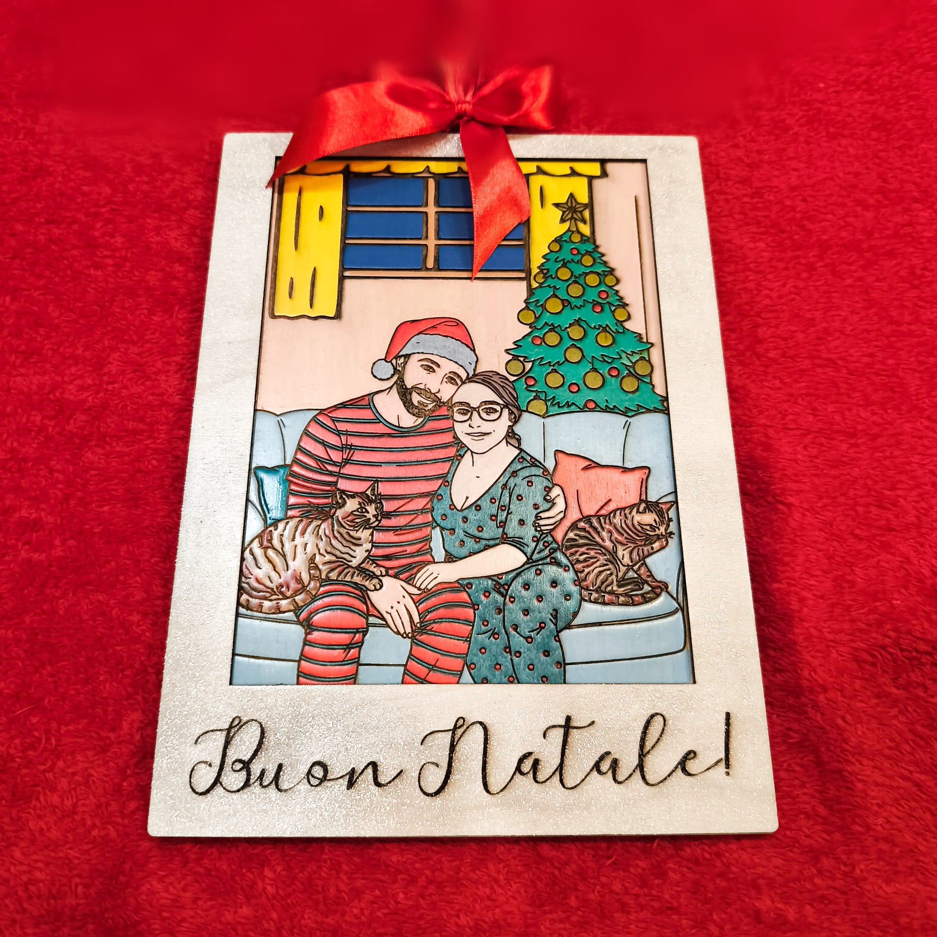 coppia in abiti natalizi seduta su divano con gatti