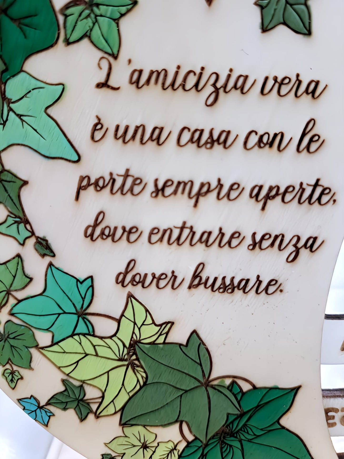 Italian friendship quote engraved on wood with green ivy leaf border